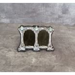 A silver Art Nouveau double picture frame, stamped sterling
