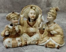 Oriental Ceramics- a Chinese porcelain 'nodding' bisque figural group depicting central emperor