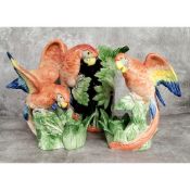 A mid century kitch Majolica type Macaw parrot jug with a matching pair of candlesticks, stamped F F