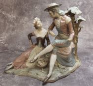 A large Lladro figural group of a gallant and his beau in an naturalistic setting (faults) approx