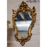 A 20th century giltwood Rococo cartouche shaped mirror, elaborate acanthus scrolling details 72cm