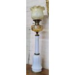 A substantial gilt bronze mounted milk glass oil lamp with wildflower painted amber coloured glass