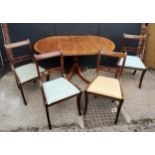 Oval Mahogany dining table and four chairs, bronze casters Table H75 x W 65 (extended 138) x D91cm
