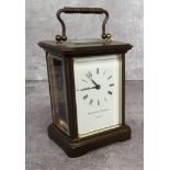 A contemporary brass cased Matthew Norman, London carriage clock, white enamel dial black Roman