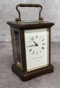 A contemporary brass cased Matthew Norman, London carriage clock, white enamel dial black Roman