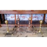 Two pairs of substantial country house brass andirons terminating in ball finials