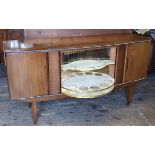 A mid 20th century teak Beautility metamorphic cocktail cabinet and sideboard with swivel action