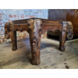 Tribal - A 20th century tribal occasional table with ornately carved legs depicting elephants.