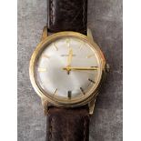 A Garrard 9ct gold gentleman's wristwatch, 17 jewel movement, stamped Garrard, a silvered dial, gold