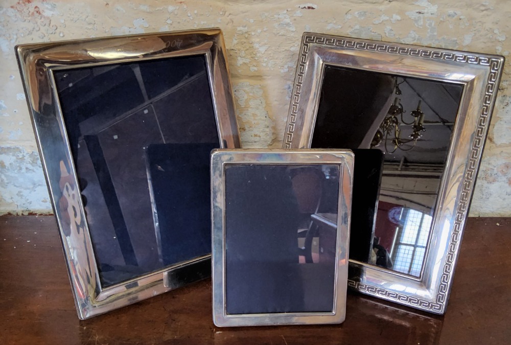 Three silver photograph frames