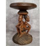 Tribal - a 20th century African elder carving with three seated male carved column, with carved base