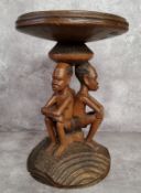 Tribal - a 20th century African elder carving with three seated male carved column, with carved base