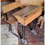 An early 20th century child's school desk, wrought iron base