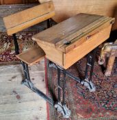 An early 20th century child's school desk, wrought iron base