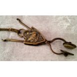 A Victorian Eyre's Patent brass skirt lifter of scissor form, the heraldic shield shaped sliding