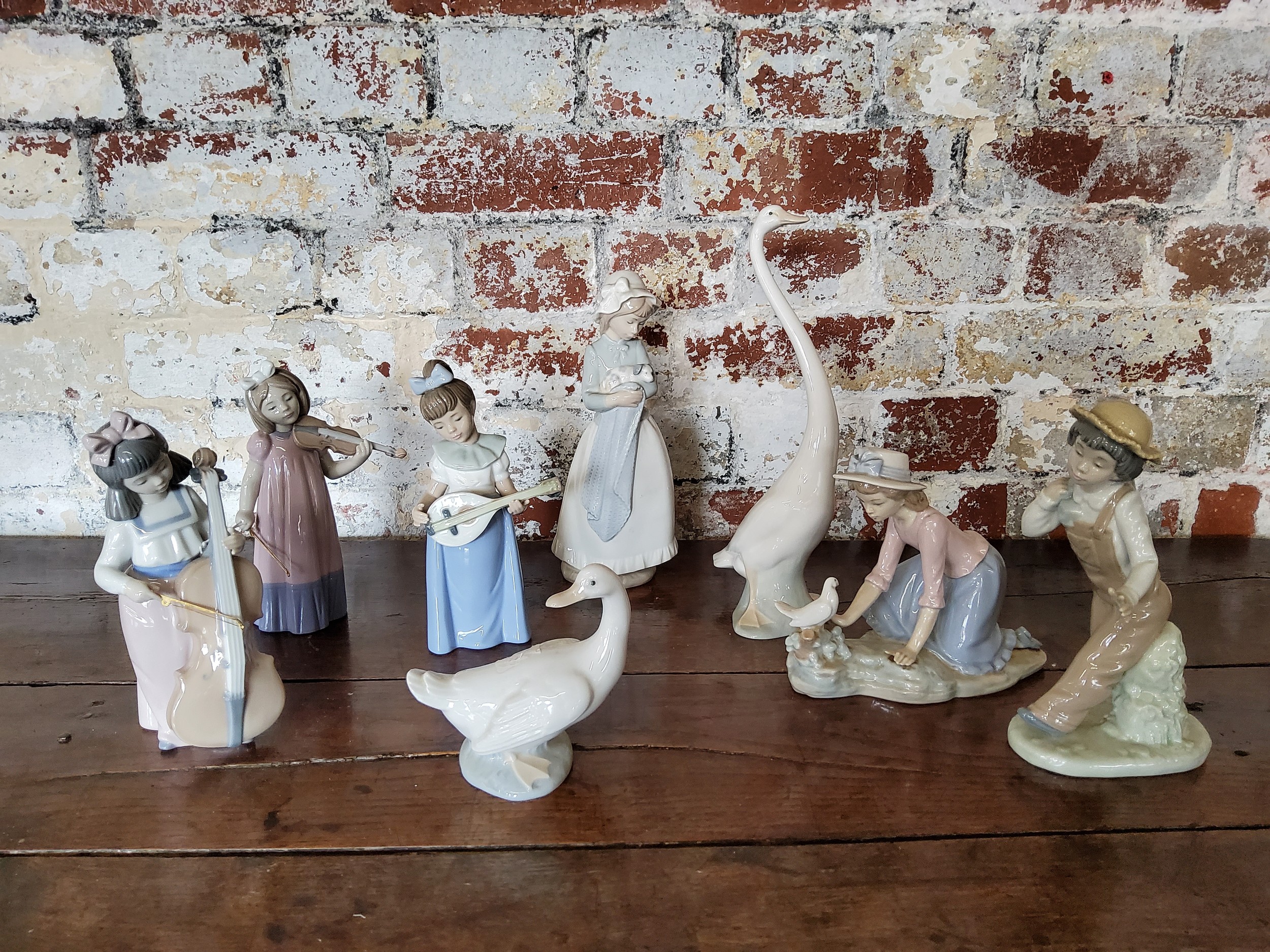 NAO by Lladro figures including a long necked goose; another smaller; Mandolin player, Violinist &