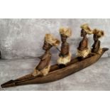 Tribal - a large African carving of a boat, each figure with hyena fur traditional tribal dress 75cm