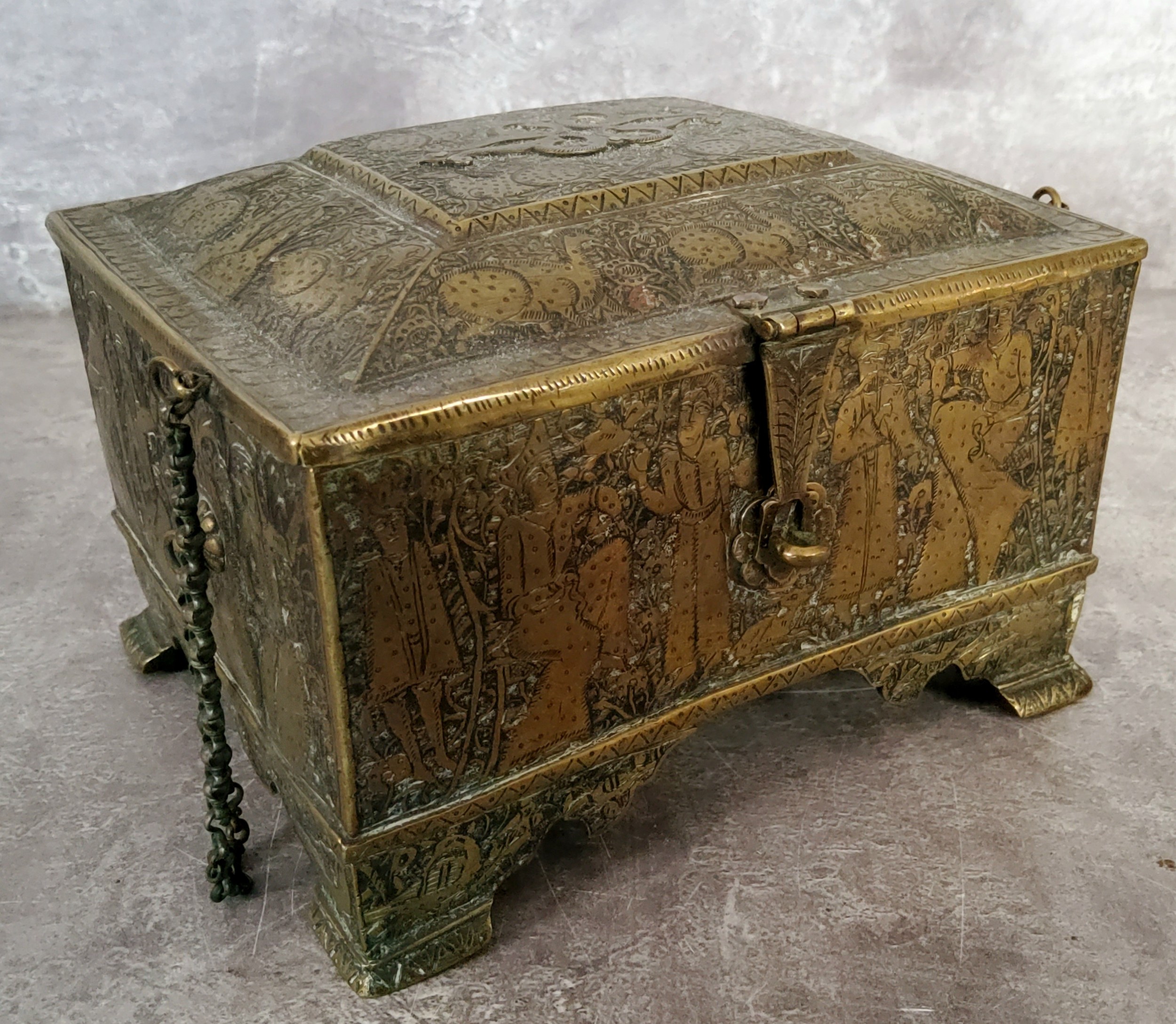 A 19th century Persian casket, profusely chased with mythical beasts, Kings and Queens (