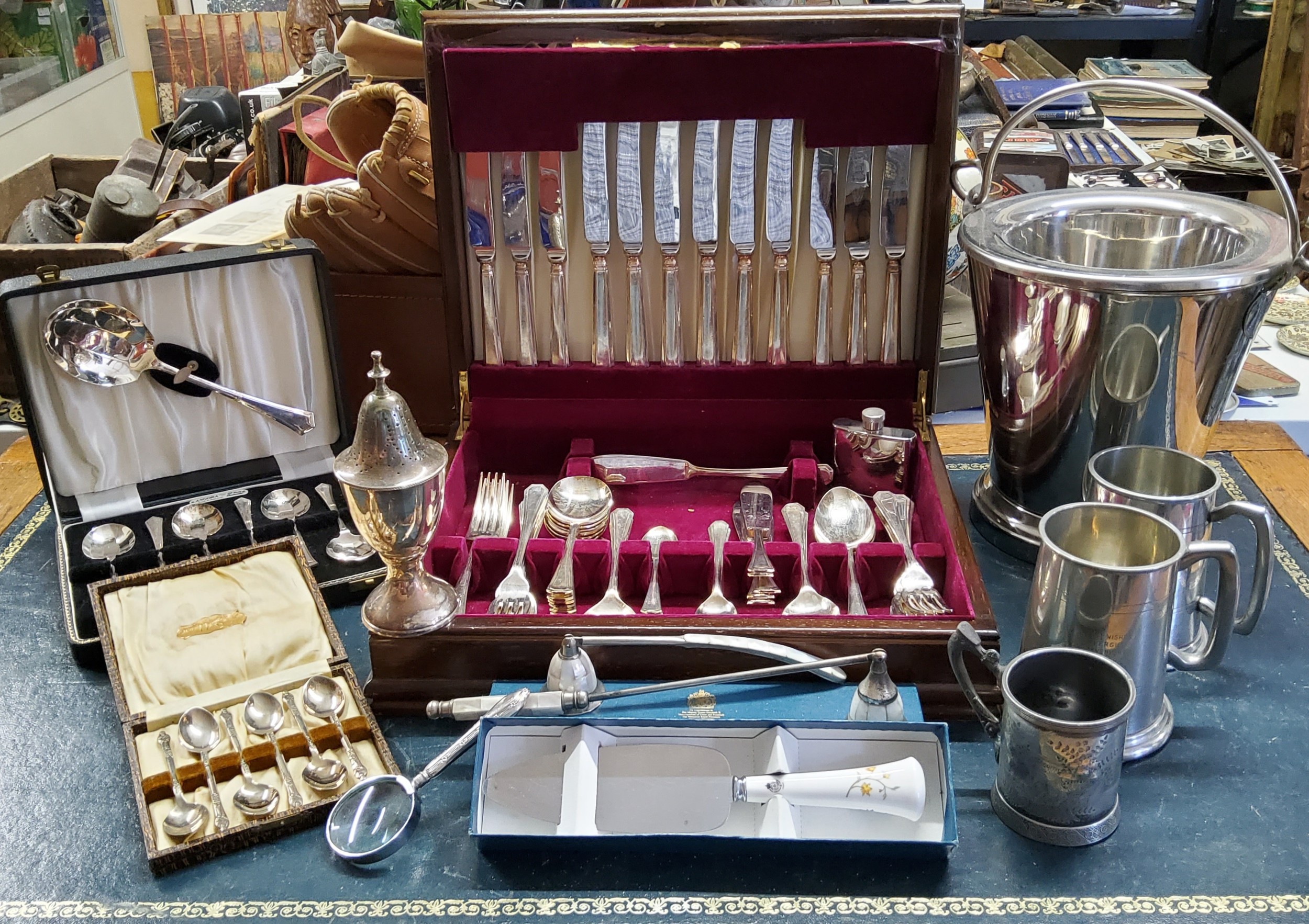 Silverplate - a silver hafted magnifying glass; a canteen of Sheffield Art Deco inspired flatware;