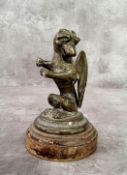 Automobilia - A bronze car mascot in the form of a seated Gryphon / griffin with folded wings