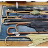 Walking sticks and parasols including a Victorian silver mounted walking cane, ebonised shaft;