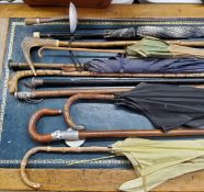 Walking sticks and parasols including a Victorian silver mounted walking cane, ebonised shaft;