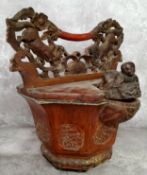 An unusual cinnabar lacquered Chinese rice basket, with Dog Of Fo and blossoming carved carrying