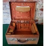 Tan leather E H monogrammed traveling case with conents, including, silver topped glass jars/