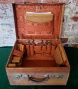 Tan leather E H monogrammed traveling case with conents, including, silver topped glass jars/