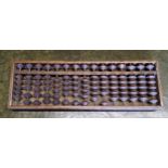 An early 20th century Chinese padouk wood abacus 33cm wide