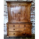 An early Victorian farmhouse pitch pine housekeeper's cupboard, the oversailing ogee cornice above