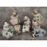Five Lladro clown figures including Girl with Domino, No. 1175; Boy with Accordion on Domino, No.