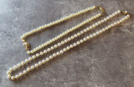 A pearl necklace (slight blush colour) 9ct gold clasp set with a central pearl; another faux pearls;