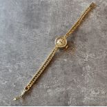 A 9ct gold lady's Omega watch, 17 jewel movement, silver dial black baton markers, integral fancy