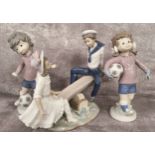 Lladro Sport Billy girl & boy footballers c.1978; a Lladro Seesaw figural group (3)