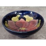 A Moorcroft Clematis pattern pedestal dish, tube lined with a dusty pink flower on a blue ground