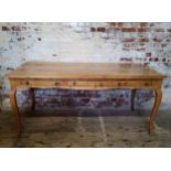 An impressive early 19th century French farmhouse pine double desk, raised on tall cabriole legs,