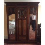 A Victorian burr walnut and mahogany double wardrobe, the oversailing cornice above central blind