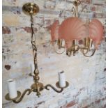 A five-branch chandelier with pink clam shell glass shades; another 3-branch brass chandelier