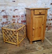 A farmhouse pine bedside cabinet with drawer above  cupboard, raised on bun feet; square bamboo