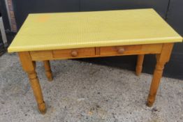A farmhouse pine side table with two small drawers to frieze, covered in fitted yellow plastic "