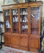 A Regency Revival flamed mahogany library breakfront bookcase, 20th century. Excellent condition.