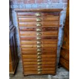 A late 19th century farmhouse pine bank of sixteen collectors drawers / printers drawers with