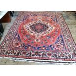 A very large hand knotted Persian Isfahan carpet on a bold red, blue and ivory ground, central
