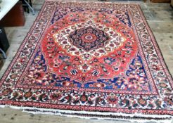 A very large hand knotted Persian Isfahan carpet on a bold red, blue and ivory ground, central