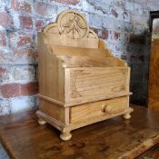 A substantial farmhouse pine letter rack above one drawer, the back panel carved with fruiting
