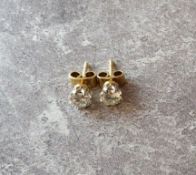 Pair of round brilliant-cut diamond ear studs, claw set yellow & white metal mounts, approx. 0.