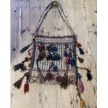 Himalayan Art - a  hand knotted Tibetan textile bag, profusely decorated with geometrical panels and