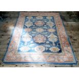 A mid 20th century Eastern style rug in pastel tones of blue, ivory, terracotta and green by