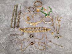 A jewellery box full of gold plated and yellow metal jewellery including chains, necklaces,